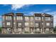 Modern townhome with stone accents and a welcoming entrance, set against a blue sky at 6285 N Kirk St, Aurora, CO 80019