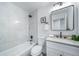 Bathroom with white tile, shower over tub, and modern sink at 16086 E Ithaca Pl # D, Aurora, CO 80013