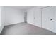 Neutral bedroom with closet and adjacent room with a louvered door at 16086 E Ithaca Pl # D, Aurora, CO 80013