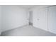 Neutral bedroom with closet and adjacent room with a louvered door at 16086 E Ithaca Pl # D, Aurora, CO 80013