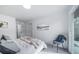 Airy bedroom with a sliding glass door, neutral tones, soft bedding, and a comfortable chair at 16086 E Ithaca Pl # D, Aurora, CO 80013