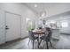 Bright dining area features modern lighting and seamless flow to the kitchen at 16086 E Ithaca Pl # D, Aurora, CO 80013