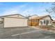 Exterior view of a home with a detached garage and an adjacent parking area at 16086 E Ithaca Pl # D, Aurora, CO 80013