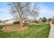 Charming single-story home featuring a lush green lawn and mature trees in a serene neighborhood at 16086 E Ithaca Pl # D, Aurora, CO 80013