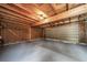 Spacious unfinished garage with exposed beams and a roll-up door at 16086 E Ithaca Pl # D, Aurora, CO 80013