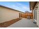 Concrete patio features wood chips and a door into the yard at 16086 E Ithaca Pl # D, Aurora, CO 80013