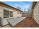 Concrete patio features wood chips and sliding glass door at 16086 E Ithaca Pl # D, Aurora, CO 80013
