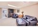 Cozy basement seating area with a comfortable leather sofa, ottoman, and built-in shelves at 4505 S Yosemite St # 102, Denver, CO 80237