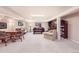 Open basement living area with a piano, couches, and a table with chairs at 4505 S Yosemite St # 102, Denver, CO 80237