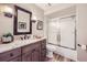 Charming bathroom featuring granite counters, framed mirror, and shower-tub combo at 4505 S Yosemite St # 102, Denver, CO 80237