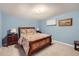 Serene blue bedroom with traditional wood furniture and a paisley bedspread at 4505 S Yosemite St # 102, Denver, CO 80237
