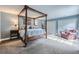 Spacious bedroom with four-poster bed, soft carpet, and ample natural light at 4505 S Yosemite St # 102, Denver, CO 80237