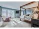 Bright bedroom featuring french doors, four-poster bed, and comfy chair at 4505 S Yosemite St # 102, Denver, CO 80237