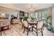 Dining room with decorative chandelier, hardwood floors, and ample seating at 4505 S Yosemite St # 102, Denver, CO 80237