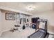 Home gym featuring exercise equipment, a television and workout accessories at 4505 S Yosemite St # 102, Denver, CO 80237