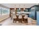 Modern kitchen with custom cabinets, a large island, pendant lighting, and stainless-steel appliances at 4505 S Yosemite St # 102, Denver, CO 80237