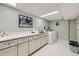 Basement laundry room with a white quartz countertop, sink, washer, and dryer at 4505 S Yosemite St # 102, Denver, CO 80237