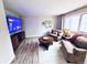Inviting living room with hardwood floors, large TV, and comfortable seating area at 4505 S Yosemite St # 102, Denver, CO 80237