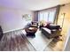 Bright living room featuring hardwood floors, area rug, and large window at 4505 S Yosemite St # 102, Denver, CO 80237