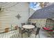 Cozy back patio with a round table, chairs, a hanging chair, and string lights at 4505 S Yosemite St # 102, Denver, CO 80237