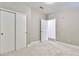 Bright bedroom features neutral walls, soft carpet, white trim, and closet with sliding doors at 2374 S University Blvd # 503, Denver, CO 80210
