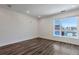 Bright, modern living room with wood floors and a large window overlooking the neighborhood at 2374 S University Blvd # 503, Denver, CO 80210