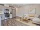 Open concept living area with modern kitchen, stainless steel appliances, and comfortable seating at 2374 S University Blvd # 503, Denver, CO 80210
