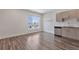 Open-concept living room with wood floors and an adjacent kitchen at 2374 S University Blvd # 503, Denver, CO 80210