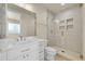 Bright bathroom with glass-enclosed shower, white vanity with gold hardware, and a sleek, modern design at 7572 Kelty Trl, Franktown, CO 80116