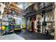 Spacious unfinished basement used as an at home gym with weight lifting equipment and overhead lighting at 6787 Serena Ave, Castle Pines, CO 80108