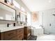 Bright bathroom with double vanity, modern fixtures, and separate soaking tub and shower at 6787 Serena Ave, Castle Pines, CO 80108