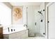 Modern bathroom with marble tile, glass shower, and soaking tub at 6787 Serena Ave, Castle Pines, CO 80108