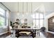 Elegant dining room featuring modern pendant lighting, a spacious table, and large windows for ample natural light at 6787 Serena Ave, Castle Pines, CO 80108