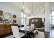 Bright dining room showcasing modern decor, wooden accent wall, and comfortable seating, ideal for entertaining at 6787 Serena Ave, Castle Pines, CO 80108