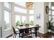 Charming dining area with a rustic wooden table, large windows, and stylish decor, creating an inviting atmosphere at 6787 Serena Ave, Castle Pines, CO 80108