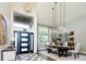 Grand entryway with soaring ceilings, stylish lighting, and modern front door, creating a welcoming first impression at 6787 Serena Ave, Castle Pines, CO 80108