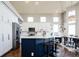 Bright kitchen with stainless appliances, island with seating, and a view to dining area at 6787 Serena Ave, Castle Pines, CO 80108