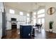 Bright and airy kitchen with white cabinets, a large island, and an adjacent dining area filled with natural light at 6787 Serena Ave, Castle Pines, CO 80108