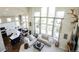 Bright open concept living room with soaring ceilings, large windows, and modern finishes and hardwood flooring at 6787 Serena Ave, Castle Pines, CO 80108