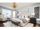 Main bedroom with decorative light fixture, gray shiplap, and neutral decor at 6787 Serena Ave, Castle Pines, CO 80108
