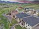 Aerial view of houses in a residential area with green grass and mountain views at 9754 W Ontario Pl, Littleton, CO 80128