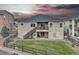 Two-story home with a deck, patio, and fenced backyard at 9754 W Ontario Pl, Littleton, CO 80128