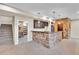 Finished basement with a stone bar, pendant lighting, stairs, and a doorway to the utility room at 9754 W Ontario Pl, Littleton, CO 80128