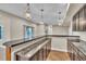 Finished basement with a wet bar, cabinets, granite countertops, and pendant lighting at 9754 W Ontario Pl, Littleton, CO 80128