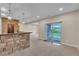 Finished basement with a stone bar, sliding glass doors, and neutral carpet at 9754 W Ontario Pl, Littleton, CO 80128