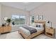 Cozy bedroom featuring a large window, neutral decor, and light wood furniture at 9754 W Ontario Pl, Littleton, CO 80128