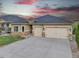 Stucco home with stone accents, two-car garage, and well-maintained landscaping at 9754 W Ontario Pl, Littleton, CO 80128