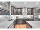 Modern kitchen with stainless steel appliances, white subway tile backsplash, and dark wooden cabinets at 9754 W Ontario Pl, Littleton, CO 80128