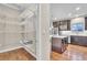 View of a kitchen and pantry with white subway tiles, stainless steel appliances and wire shelving at 9754 W Ontario Pl, Littleton, CO 80128