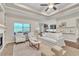Bright living room with tray ceilings, fireplace, and views of the backyard at 9754 W Ontario Pl, Littleton, CO 80128